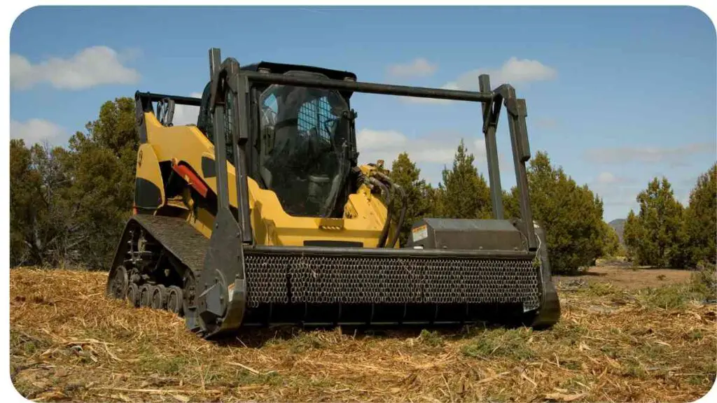 a yellow and black skid steer loader in the middle of a field