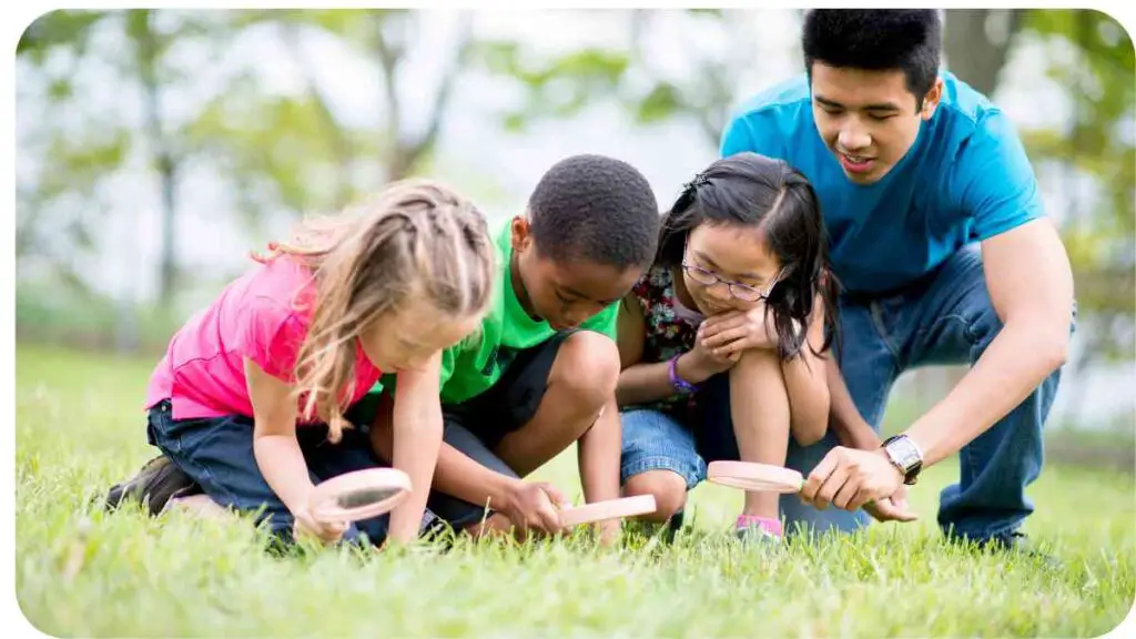 a group of children playing in the grass with a person holding a magnifying glass