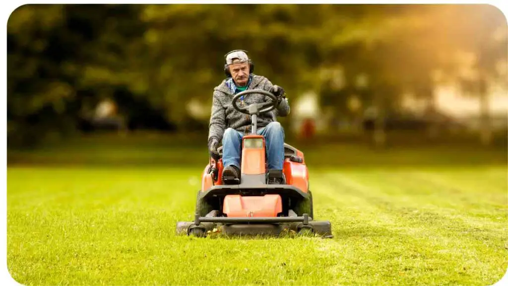 a person on a lawn mower in the middle of a field