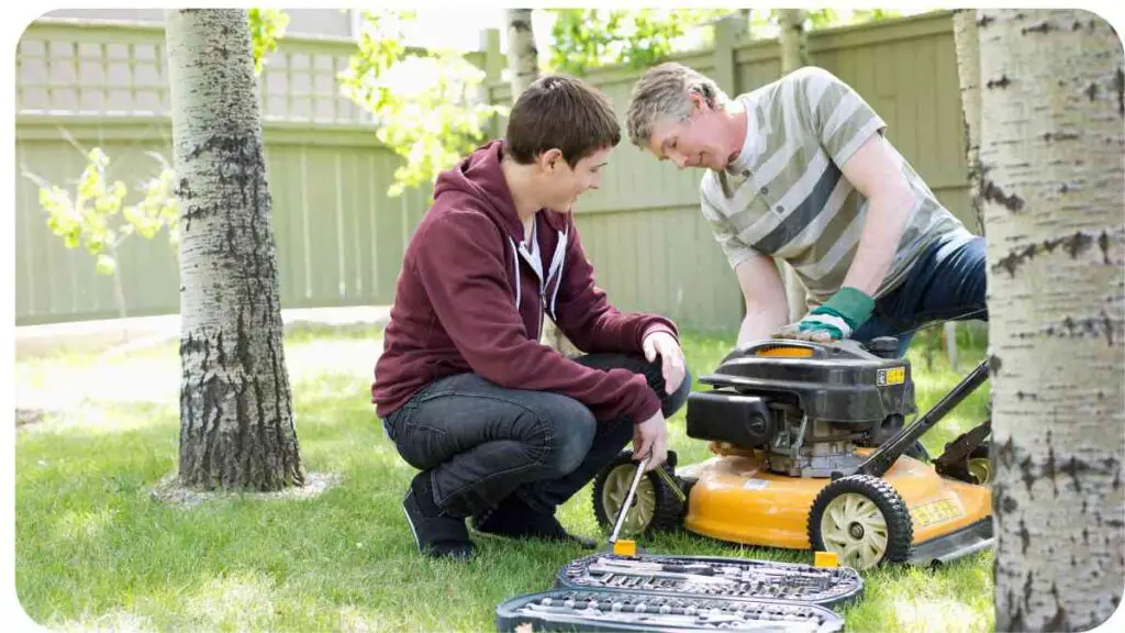 two people working on a lawn mower in the yard