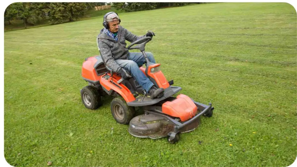 a person riding a lawn mower on a grassy field