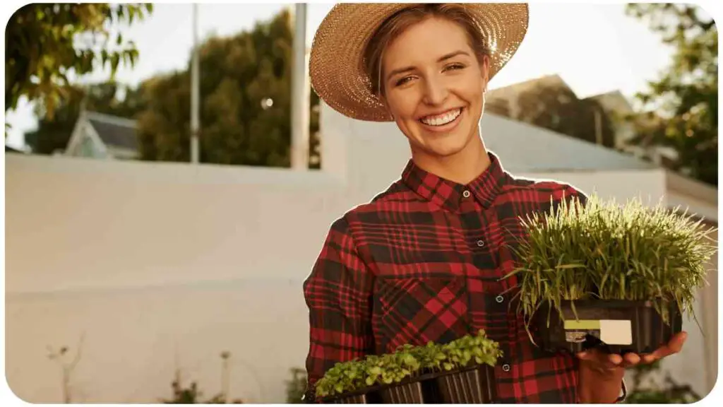 a person in a hat and plaid shirt is holding two potted plants