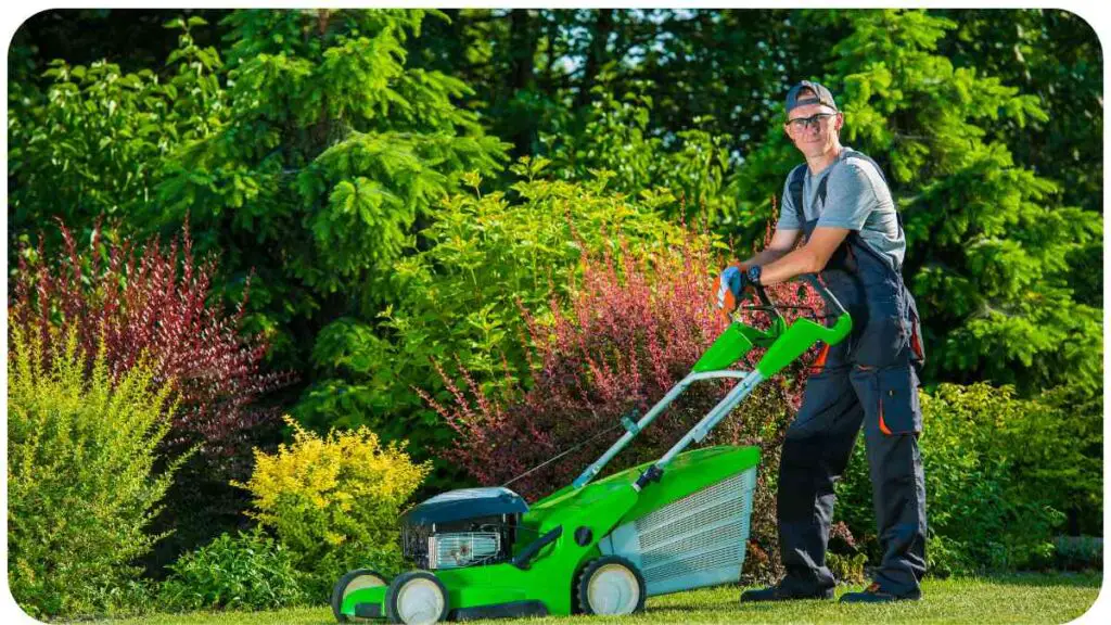 a man is mowing the lawn with a green lawn mower