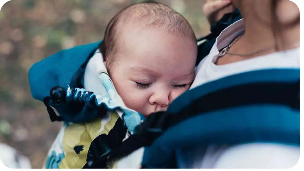 a person holding a baby in a baby carrier