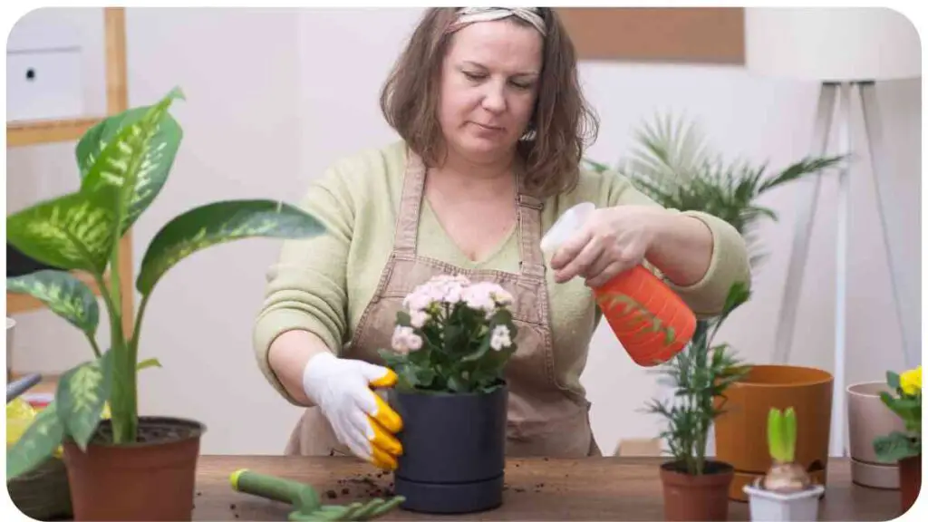 a woman in an apron is working on a potted plant