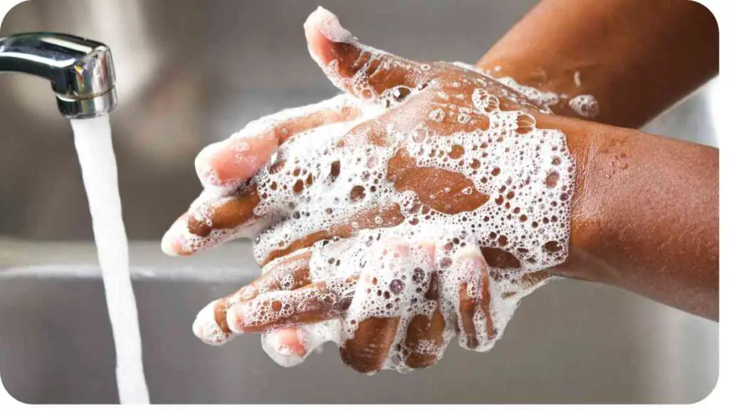 a person washing their hands with soap and water