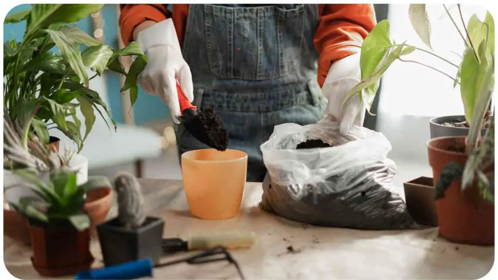 a person in overalls is holding a bag of soil and potted plants