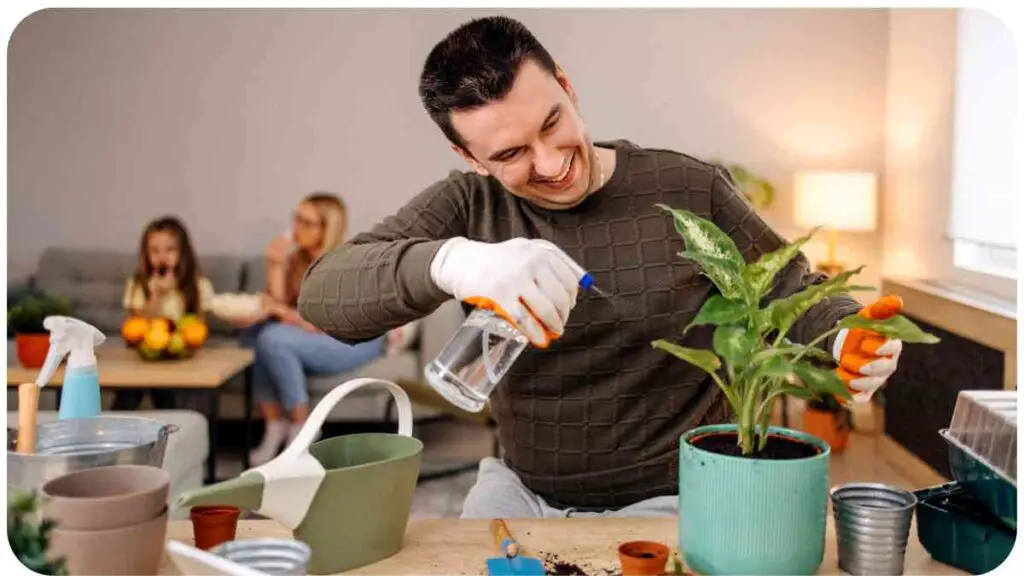 a person is watering plants in a room with other individuals in the background