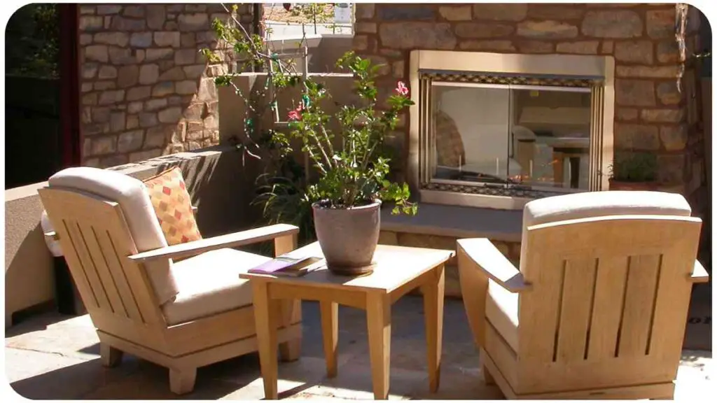 a patio with two chairs and a table in front of a fireplace