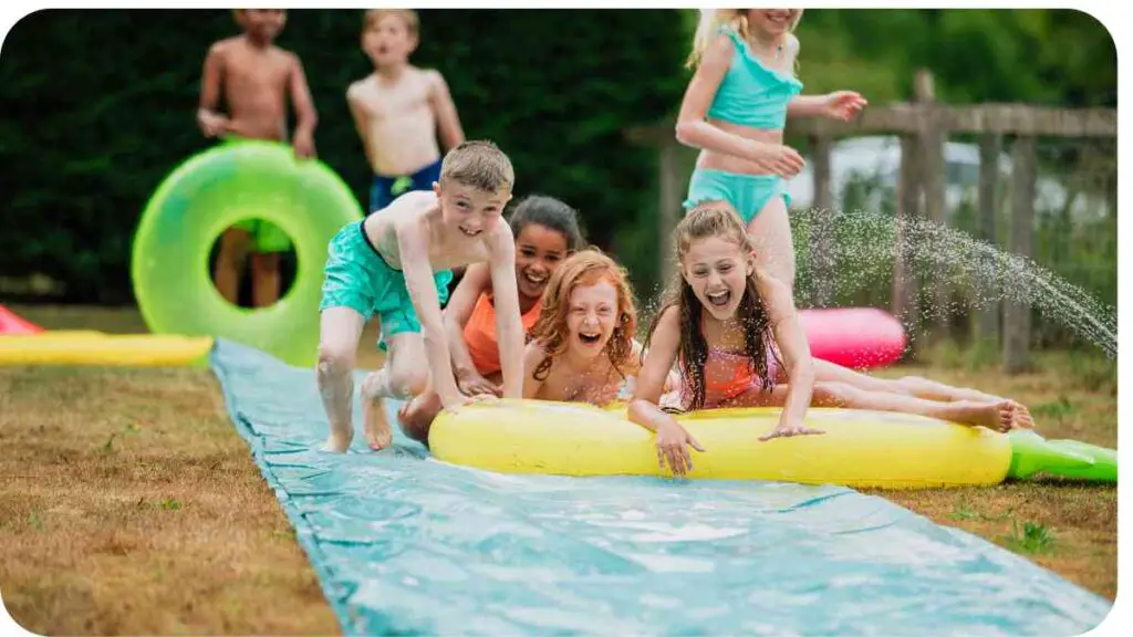 a group of children playing on an inflatable water slide