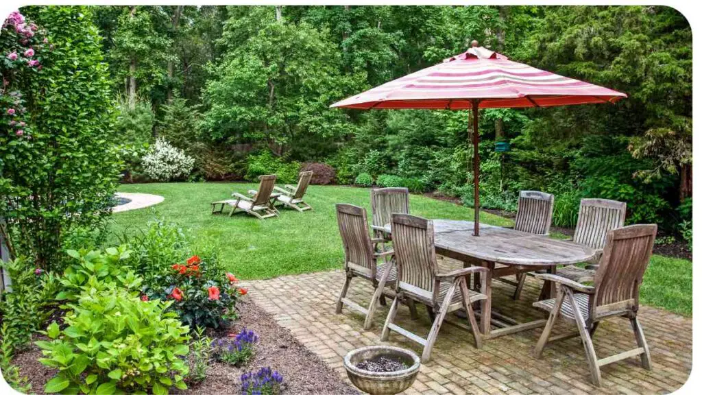 a patio with a table and chairs under an umbrella