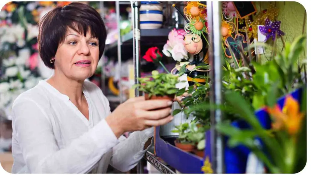 a person holding a potted plant in a flower shop