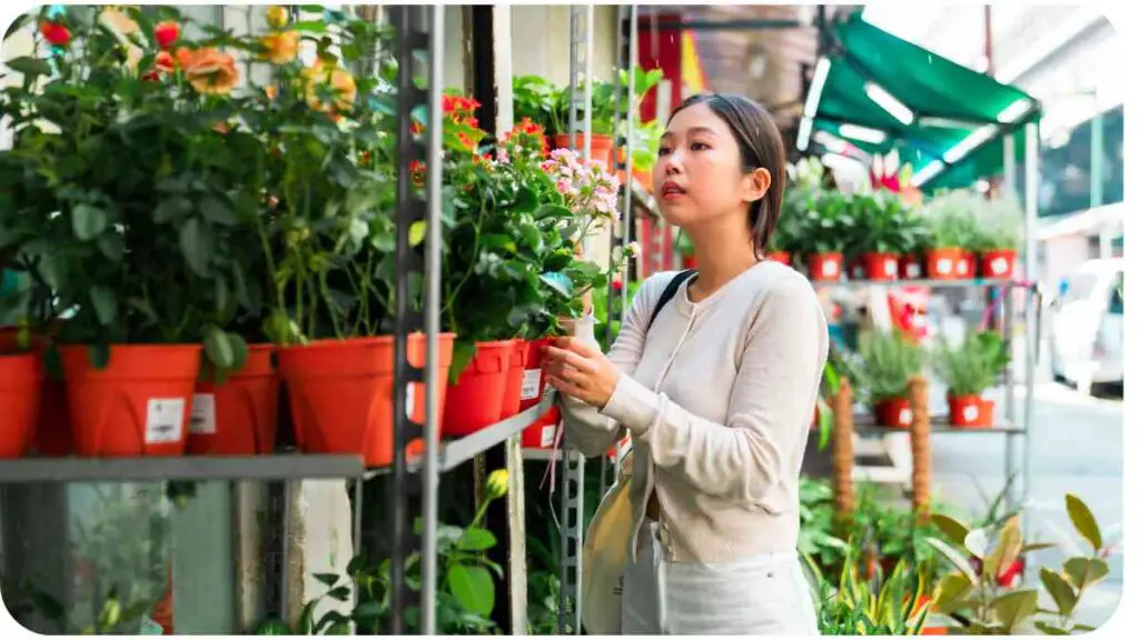 a person is looking at plants in a flower shop